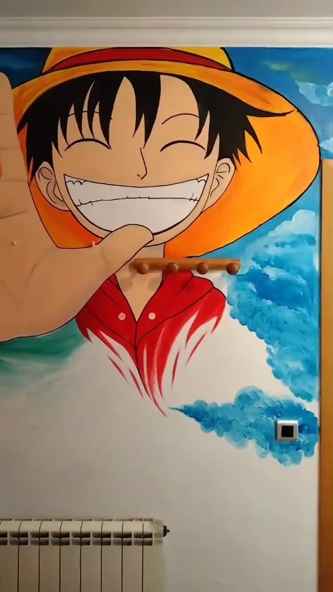 Detall d’un mural temàtic de One Piece pintat a mà en una habitació